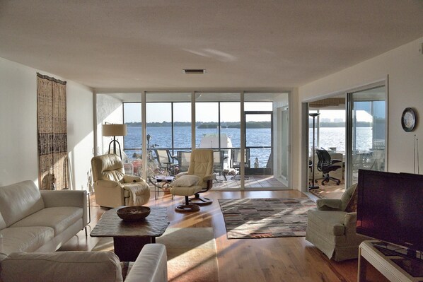 Living room with den to side.  Sweeping bay front views.