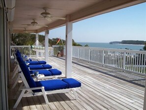 Relax on the porch--lots of comfy chairs, hammock, and dining area