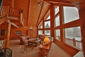 Large living room with gas stove and TV. 