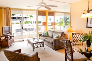 Living room has a full-length lanai and a queen-sized  pull-out sofa-bed.