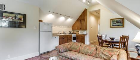 View of living/dining area showing full kitchen, including dishwasher