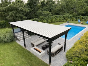 Large Pergola and Jacuzzi with new pool and stone patio with two fire features.