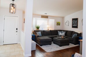 Entryway into living room and den/family room areas