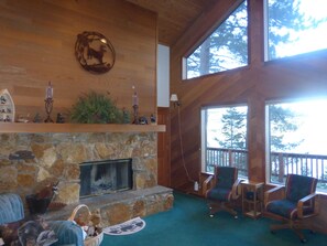 Upper living room w/high ceilings, large windows and 180 degree lake view