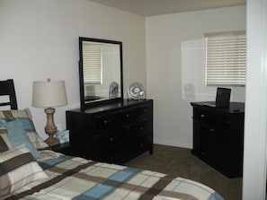 Dresser and night stands in bedroom.