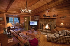 The living area with lots of twigs, antlers, crafts, and art.