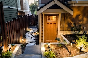 Entrance to the house is lit with artistic landscape lights.