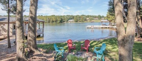 Beautiful lake front with beach, firepit and 1600 sf boathouse.