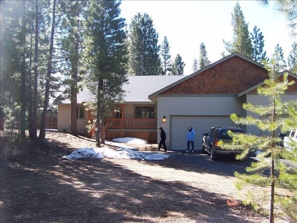 1800 sq ft home set back from the street with rustic forest in the front yard 