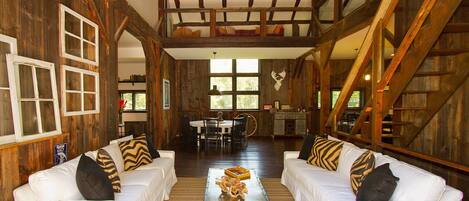 View looking in through open-air barn doors from spacious outdoor deck