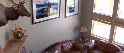 Living room view from stairs featuring 20-foot picture windows