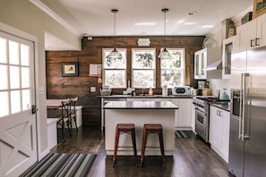 Kitchen with Viking range, dishwasher, counter seating, Keurig coffee maker