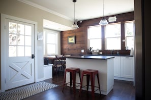 Full kitchen with Viking range, counter seating, and dining room nook table
