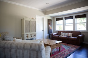 Sweet family room with chairs, leather pull-out couch with comfy queen bed