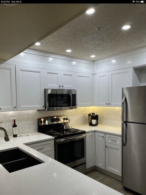 Updated kitchen with over the stove microwave. 