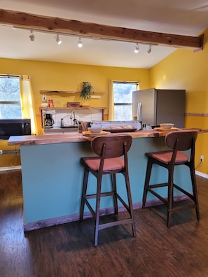 Looking into kitchen space with live edge counter top eating space