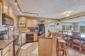 Updated and stocked kitchen with pine wood carvings