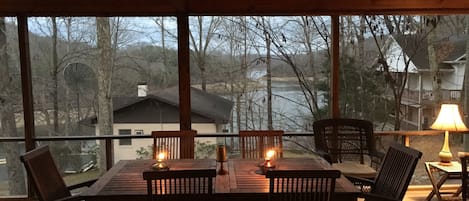 Evening dining on screen porch with lake view