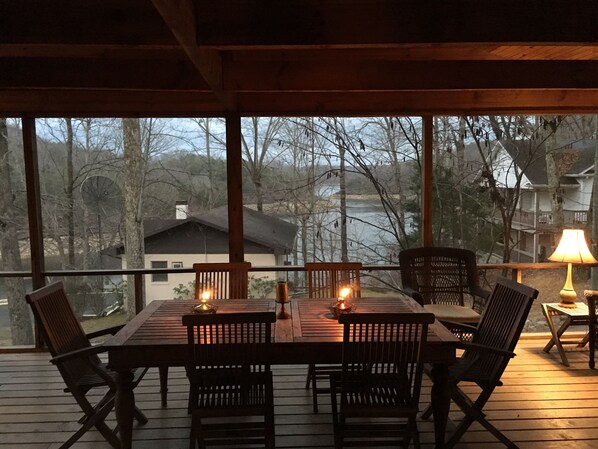 Evening dining on screen porch with lake view