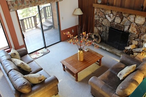 Living room with comfortable seating, fireplace and great views of the outdoors