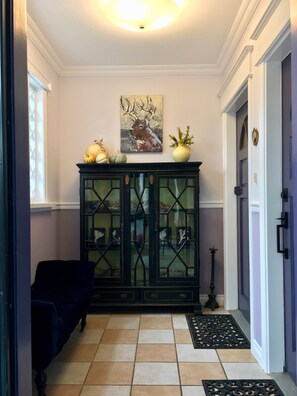 Looking into the foyer at the curio cabinet