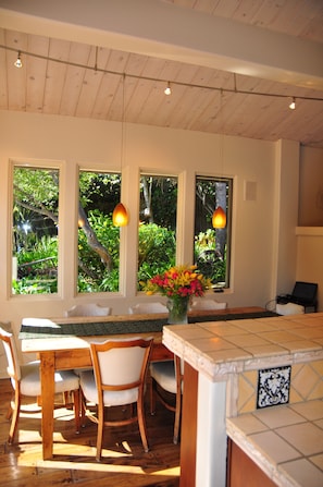The surrounding windows flood the dining/kitchen area with light.
