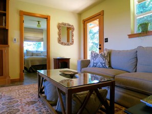 Upstairs: Living room looking into guest bedroom. Backyard & forest behind.