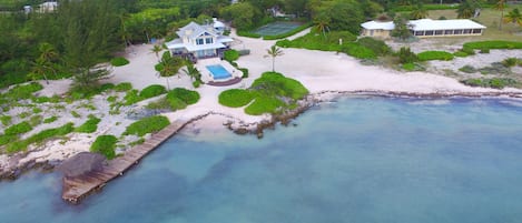 Coconut Cottage is located between the tennis court and the main yellow house. 