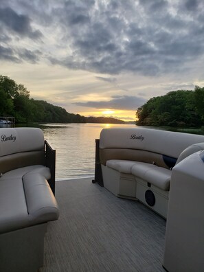 Sunset on rental boat behind house

