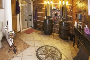 Cowgirl, cowboy bath with shower and authenic, whisky barrel sinks.