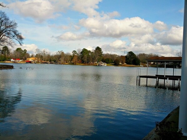 Stunning view of the lake from the covered patio, and most all of the rooms too!