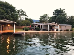 Boat lift, pier, covered patio, & one of the many flat lawn areas.