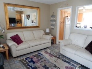 Leather sofa and love seat, in fully decorated living room