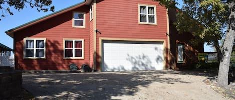 Home front with concrete parking and indoor garage