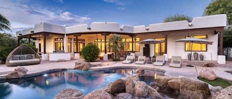 Grotto style pool with waterfall, perfect for relaxing with family and friends.