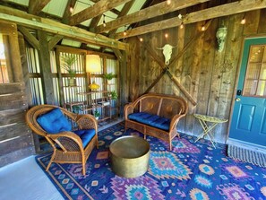 Relax in the charming covered outdoor seating area, perfect for dining, lounging, or enjoying the fresh meadow air, rain or shine!