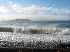 View to Merry Island with waves breaking on Welcome Beach