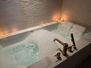 Relax in the two person jetted tub! We provide the bubbles, salts, and candles