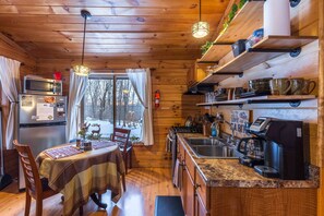The open kitchen includes the eating area.