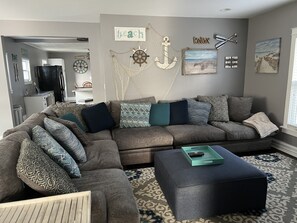 Family Room with Large Sectional couch and a 55” TV.