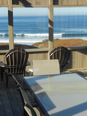 Waves crashing in front of house.