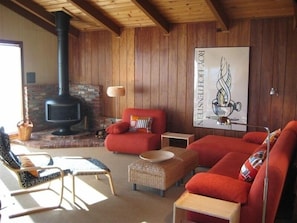 Comfortable and easy, sun filled living area with wood burning fireplace.