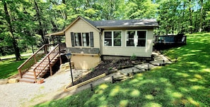 Side view of cottage showing steps and path to back decks and hot tub. 