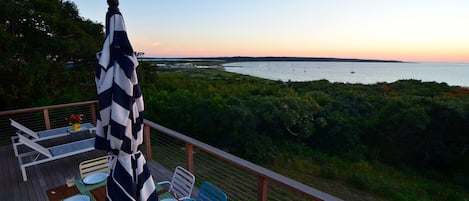 Deck with sunset water views of Menemsha Harbor & Gay Head Lighthouse.