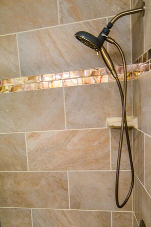 Powerful showerheads and accent tiles provide a luxurious showering experience