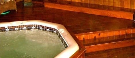 Relax in the indoor hot tub with cedar flooring after a long day at the beach!