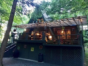 Back of the cabin with back porches, surrounded by the creek and rhododendrons.