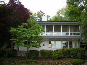 lakeside of house, screened in porch on upper level.