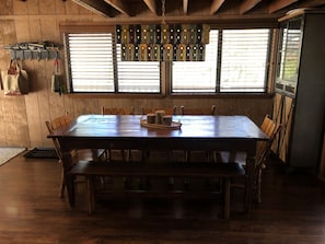 Dining area:  large country style table with seating for eight. 