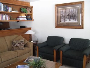 Corner of living room with pass-through to kitchen.